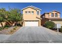 Two-story house with a white garage door and landscaping at 9570 Wenmarie Ct, Las Vegas, NV 89148