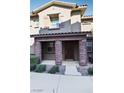 Two story townhome with a covered front porch at 104 Alamere Falls Dr, Las Vegas, NV 89138