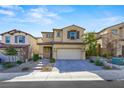 Two-story house with beige siding, gray shutters, and a brick walkway at 11857 Corenzio Ave, Las Vegas, NV 89138