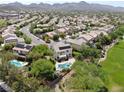 Aerial view of a residential neighborhood with houses featuring solar panels and pools at 1327 Coulisse St, Henderson, NV 89052