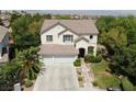 Two-story house with a double garage, landscaping, and a walkway at 1327 Coulisse St, Henderson, NV 89052