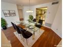 Modern glass dining table with six chairs in a bright dining room at 1944 Las Palmas Ln # 175, Laughlin, NV 89029