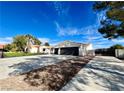 House exterior showcasing a two-car garage and a long driveway at 2250 Shaw Cir, Las Vegas, NV 89117