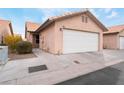 Attached single car garage with a white door and neutral colored exterior at 312 Crosswind Way, Las Vegas, NV 89145