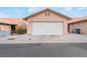 Attached single car garage with a white door and neutral colored exterior at 312 Crosswind Way, Las Vegas, NV 89145