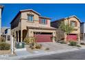 View of the property featuring an attached two-car garage, low maintenance landscaping, and neutral color palette at 3812 Seyfert Ave, North Las Vegas, NV 89084