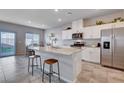 Modern kitchen with granite counters, stainless steel appliances, and bar stool seating at 3812 Seyfert Ave, North Las Vegas, NV 89084