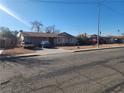 Ranch style home with a spacious front yard and driveway at 3867 Jewel Ave, Las Vegas, NV 89121