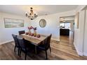 Bright dining room with wood table, chandelier, and hardwood floors at 390 Peaceful St, Las Vegas, NV 89110