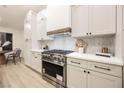 Modern kitchen with white cabinets, stainless steel appliances, and quartz countertops at 4016 Tyler William Ln, Las Vegas, NV 89130