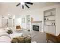 Bright and airy living room featuring a modern fireplace and built-in shelving at 4016 Tyler William Ln, Las Vegas, NV 89130