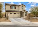 Two-story house with beige exterior, brown accents, and a two-car garage at 4904 Siglo St, North Las Vegas, NV 89031