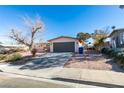 House exterior featuring a large tree and driveway at 607 Sierra Ln, Henderson, NV 89002