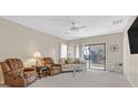 Living room with two armchairs, sofa, and glass-top coffee table at 6075 Jutland Ave, Las Vegas, NV 89122