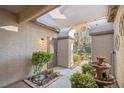 Inviting courtyard entry with fountain, shade structure, and lush landscaping at 7220 Elderly Ave, Las Vegas, NV 89131