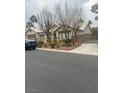 House exterior with a three-car garage and gated driveway at 7220 Elderly Ave, Las Vegas, NV 89131