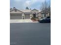 Single-story house with three-car garage and landscaped front yard at 7220 Elderly Ave, Las Vegas, NV 89131