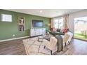 Living room with green accent wall and access to backyard at 791 Ruby Sedona Ave, North Las Vegas, NV 89081