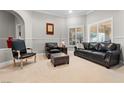 Cozy sitting area featuring leather furniture and a large window at 7944 Marbella Cir, Las Vegas, NV 89128