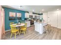 Modern kitchen with white cabinets, teal accent wall, and island at 9449 Peaceful River Ave # Lot 18, Las Vegas, NV 89178