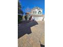 Beautiful two-story home with a well-manicured front yard and a spacious driveway leading to a two-car garage at 10337 Adams Chase St, Las Vegas, NV 89183