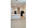 Bright kitchen featuring white cabinetry, tile floors, and modern appliances, perfect for cooking and entertaining at 10337 Adams Chase St, Las Vegas, NV 89183