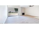 Living room with fireplace, sliding glass doors, and light wood flooring at 3339 Duece St, Las Vegas, NV 89121