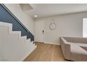 Bright entryway features modern staircase, neutral color palette, and stylish light wood-look flooring at 3473 Monte Carlo Dr, Las Vegas, NV 89121