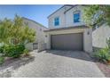 Beautiful home with a two-car garage, appealing architecture, and low-maintenance landscape at 365 Andy Wheeler Dr, Henderson, NV 89011
