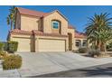 Charming two-story home with a red tile roof, three car garage, and desert landscaping at 412 Lost Trail Dr, Henderson, NV 89014