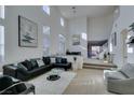 Spacious living room with high ceilings and L-shaped sectional sofa at 5859 Noble Stand St, Las Vegas, NV 89148