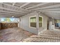 Cozy covered patio features stone flooring and unique stone accent wall at 632 Avenue D, Boulder City, NV 89005