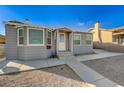 A well-maintained single-story home with neutral paint, trimmed windows and a concrete walkway at 632 D, Boulder City, NV 89005