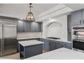 Modern kitchen with gray cabinetry, stainless steel appliances, and marble countertops at 6442 Bright Nimbus Ave, Las Vegas, NV 89139