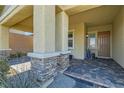 Covered entryway with stone columns and a brick paved porch at 757 Goodman Cove St, Henderson, NV 89011