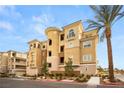 Exterior shot of a multi-story residential building with a stucco facade and manicured landscaping at 9145 Las Manaitas Ave # 401, Las Vegas, NV 89144