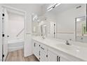 Bathroom with double vanity and large mirror at 9901 Trailwood Dr # 1058, Las Vegas, NV 89134