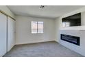 Cozy bedroom features plush carpet, neutral walls, and a modern fireplace at , Las Vegas, NV 89128
