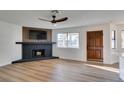 Bright living room with a modern fireplace, updated flooring, and a view to the outside at , Las Vegas, NV 89128