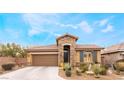 Single story home with a brown garage door and well-manicured landscaping at 10397 Station Creek Cir, Las Vegas, NV 89178