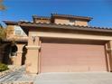 Two story house with attached garage, light colored exterior at 11173 Hickory Glen St, Las Vegas, NV 89179