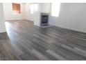 Bright living room featuring hardwood floors and fireplace at 11173 Hickory Glen St, Las Vegas, NV 89179