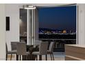Elegant dining area with glass table and city views at 1480 Macdonald Ranch Dr, Henderson, NV 89012