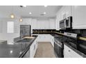 Bright kitchen featuring stainless steel appliances, and black countertops at 2033 Old Field Ave, North Las Vegas, NV 89081