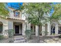 Charming two-story home featuring a welcoming entrance, covered porch, and well-maintained landscaping at 2347 Via Barranca St, Henderson, NV 89044