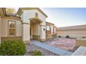 Front entryway with stone pathway and arched entry at 2771 Fort Myer Ave, Henderson, NV 89052