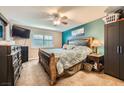 Main bedroom with dark wood furniture and teal accent wall at 2855 Geary Pl # 3205, Las Vegas, NV 89109