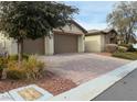 Front exterior of home with brick paved driveway and rock landscaping at 4331 Via Gallo Ct # 1, Pahrump, NV 89061