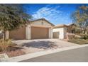 A home featuring a three-car garage with brick paved driveway and desert landscaping at 4331 Via Gallo Ct # 1, Pahrump, NV 89061