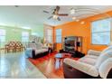 Bright living room with hardwood floors, comfortable seating, and a large TV at 5373 Sleeping Cat St, Las Vegas, NV 89122